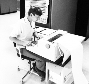 Mann som skriver på en datamaskin
